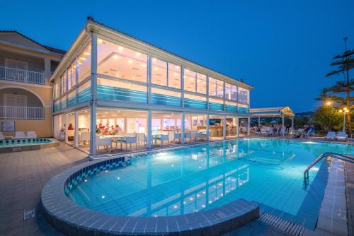 a large swimming pool in front of a building at Filoxenia Hotel Zakynthos in Tsilivi