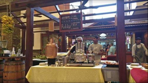 two men standing behind a counter in a restaurant at The Paul Bangalore in Bangalore