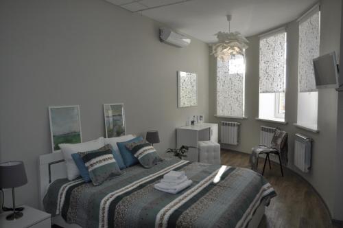 a bedroom with a large bed with blue pillows at Guest House A-suite in Omsk