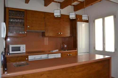 a kitchen with a counter top with a microwave at Casa Fayas in Ciutadella