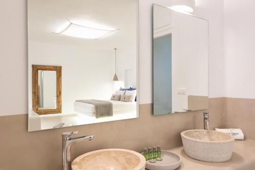 a bathroom with a sink and a mirror at Anna Platanou Suites in Agia Irini Paros