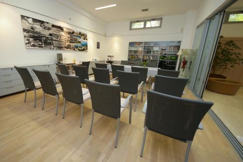 a room with rows of chairs in a store at Hotel Villa Radin in Vodice