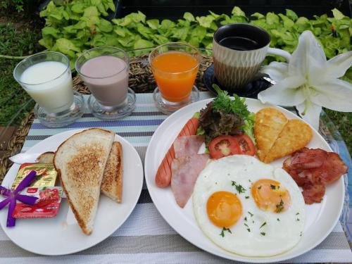 a plate of breakfast food with eggs and toast at 9 SUITE Luxury Boutique Hotel in Chiang Mai