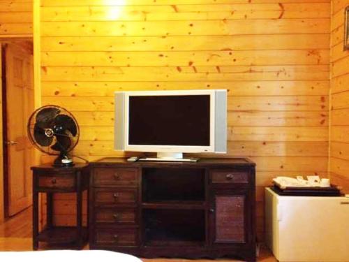 a television on top of a wooden cabinet in a room at Luka Garden BnB in Renai