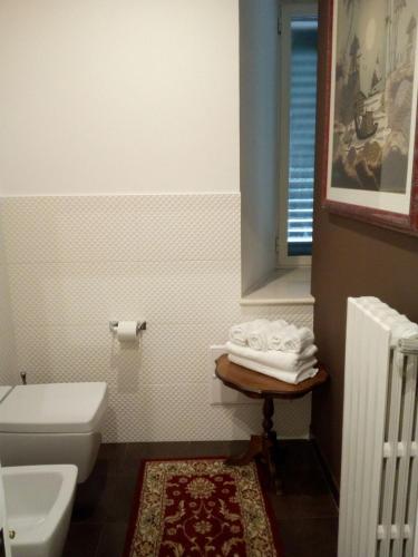a bathroom with a toilet and a sink at Palace B&B in Acquaviva delle Fonti