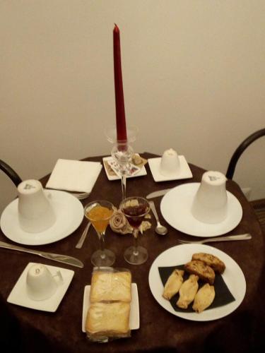 a table with plates of food and a candle at Palace B&B in Acquaviva delle Fonti