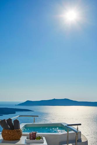 a swimming pool on the edge of the water at Aroma Suites in Fira