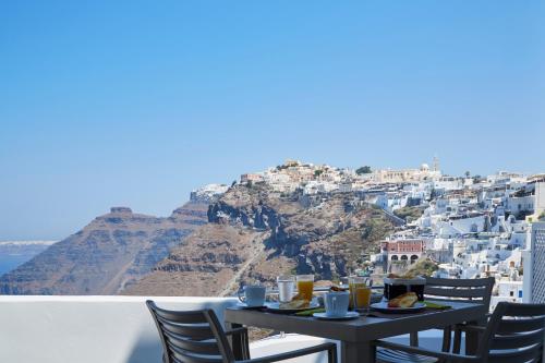 a table with food and drinks on top of a mountain at Aroma Suites in Fira