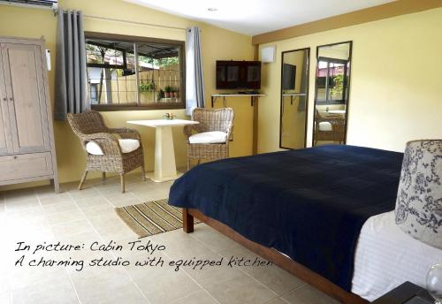 a bedroom with a bed and a table and chairs at Escape-Cabins in Ko Lanta