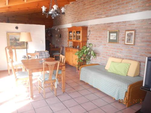 a living room with a bed and a dining room at Complejo Duque in Puerto Madryn