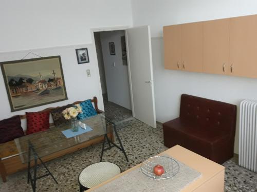 a living room with a couch and a table at Hellas Palace Rooms CENTER in Sparti