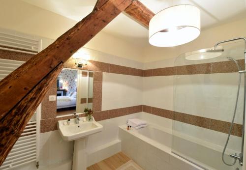 a bathroom with a sink and a shower at Chateau le Quesnoy in Chevrières