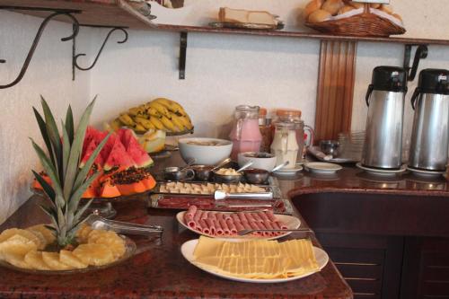 a counter top with a bunch of food on it at Pousada Solar Inn in Torres
