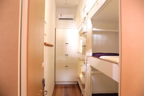 a small room with a bed and a closet at Villa 25 in Rio de Janeiro