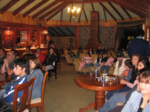 a group of people sitting at tables in a restaurant at Cabañas Blanche Neige Wellness & SPA in Las Trancas