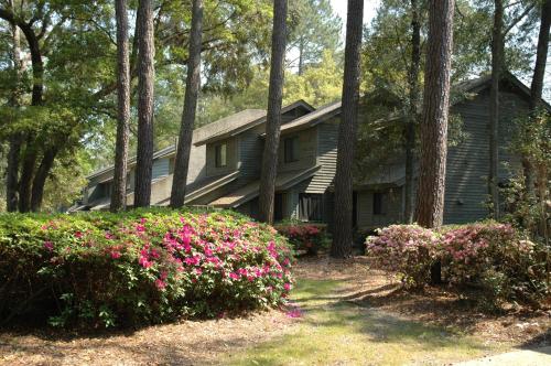 ein Haus im Wald mit Blumen davor in der Unterkunft Carolina Club by Spinnaker Resorts in Hilton Head Island