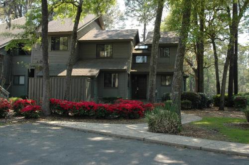 a house with red flowers in front of it at Carolina Club by Spinnaker Resorts in Hilton Head Island