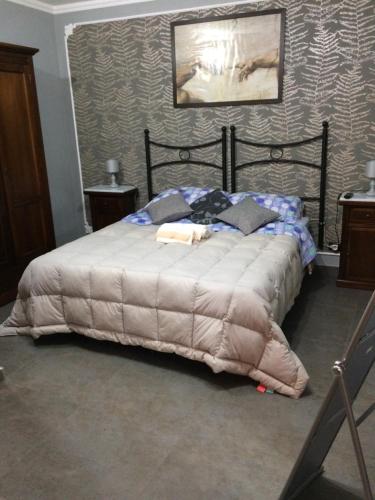 een slaapkamer met een bed met een deken erop bij Sicily Center rooms in Calascibetta