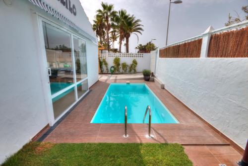 a swimming pool in the backyard of a house at Casa Cocodrilo in Playa del Ingles