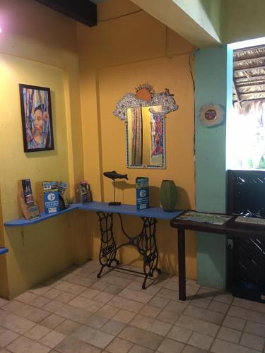 a room with a table and a mirror on the wall at Cabinas Guarana in Puerto Viejo