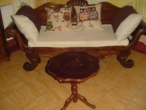 a couch with pillows and a table in a room at Everlast in Štúrovo