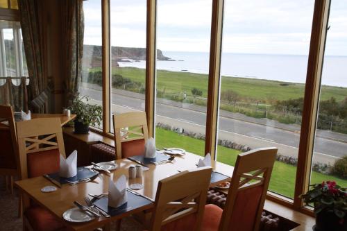 a dining room table with chairs and a window at Cullen Bay Hotel in Cullen