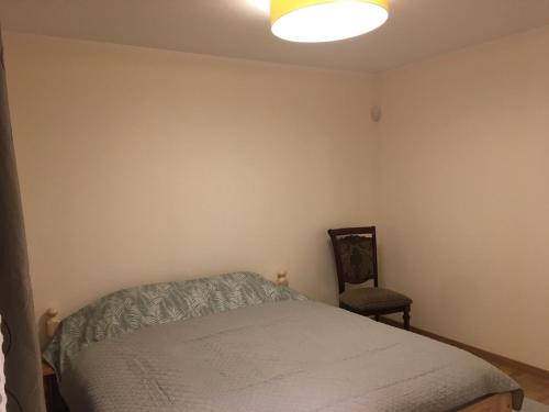 a bedroom with a bed and a chair at Ontic Wellness Apartments in Tartu