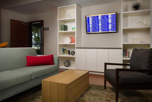 a living room with a couch and a table at Country Inn & Suites by Radisson, Portland International Airport, OR in Portland