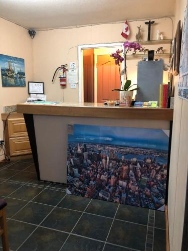 a kitchen counter with a painting of a city at Holiday House Motel in Ladysmith
