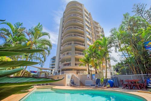 a building with a swimming pool in front of a building at Wharf Boutique Apartments in Gold Coast