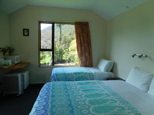 a hotel room with two beds and a window at Mountainview Makarora Accommodation in Makarora