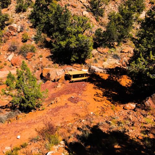 a yellow truck parked in the middle of a mountain at Zion View Camping in Hildale