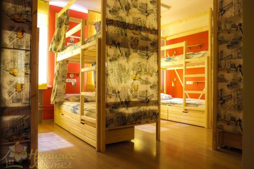 a room with two bunk beds and a mirror at HOSTEL Narciss in Novokuznetsk