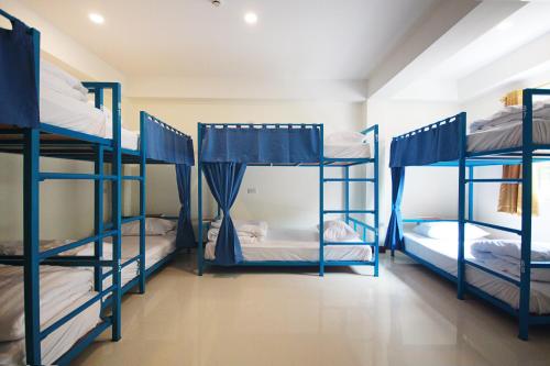 a group of bunk beds in a room at Happy Hostel in Pattaya Central