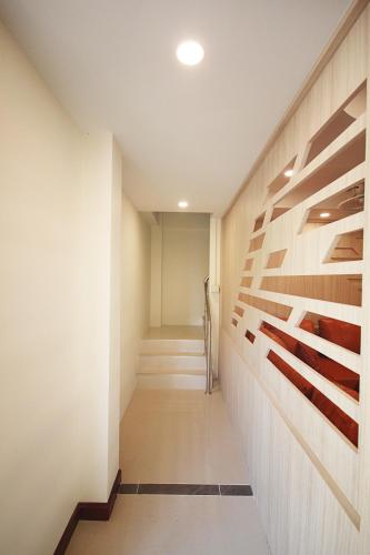 a hallway with wood dividers in a building at Happy Hostel in Pattaya Central