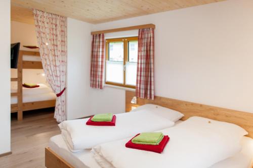 a bedroom with two beds and a bunk bed at Standlhof in Mariapfarr
