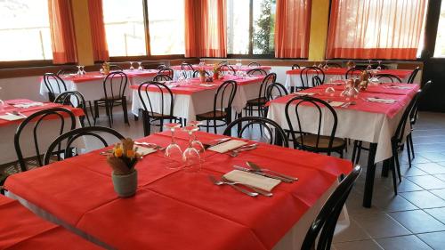 a dining room with red tables and chairs at Albergo Ristorante Lavedo in Lenno