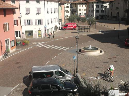 a street with cars parked in a parking lot at Residence Centrale in Dro