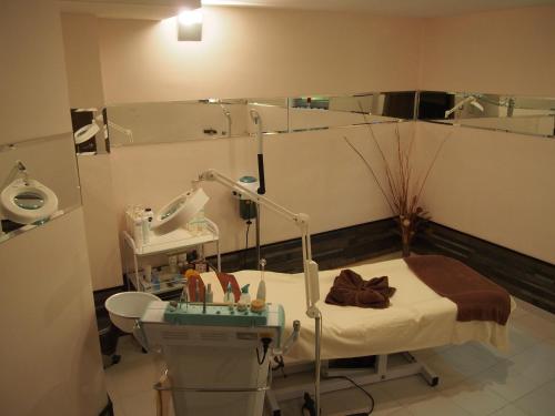 a hospital room with a bed and a mirror at Spa Hotel Ata in Varshets
