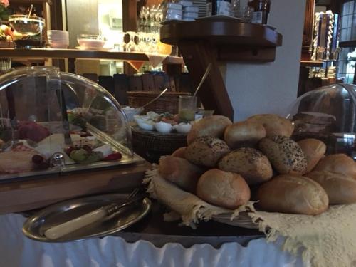 a table with a bunch of bread and other foods at Winzerstübchen in Brauneberg
