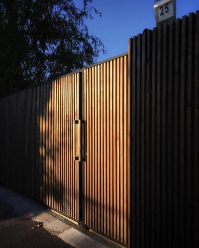 a fence with a gate with the number on it at Garden House in Timişoara