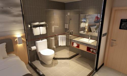 a small bathroom with a toilet and a sink at Thank Inn Chain Hotel Tianjin Meijiang Exhibition Center in Tianjin