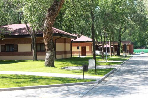 a building with a sidewalk next to a street at Tourist Resort Ribarsko Ostrvo in Novi Sad