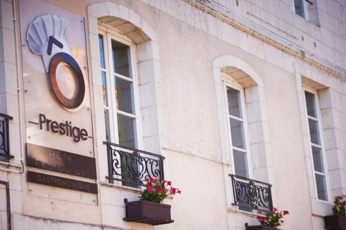 a facade of a building with windows and flowers at O Prestige in Baugé