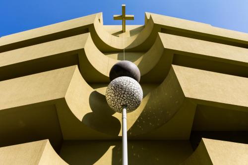 a church with a cross on the side of it at Athens Mosaico Suites & Apartments in Athens
