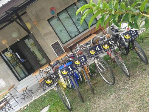 a row of bikes parked in front of a building at Sweet Dreams in Phetchaburi