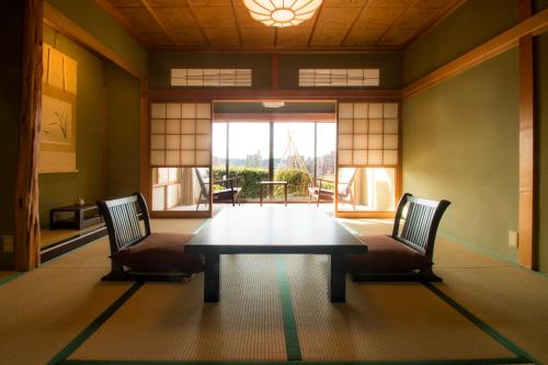 a dining room with a table and two chairs at Yamanoo in Kanazawa
