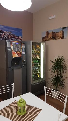 a dining room with a table and a drink refrigerator at B&B Stella Maris Sciacca Centro in Sciacca