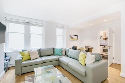 a living room with a couch and a table at Chiltern Street Serviced Apartments - Marylebone in London