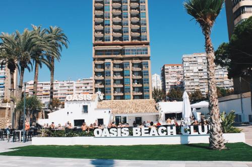 a large group of people standing in front of a building at Apartamentos Oasis Benidorm in Benidorm